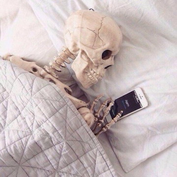 Skeleton in bed w iphone.jpg